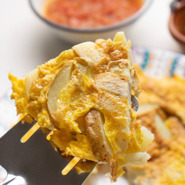 istock Spanish scrambled eggs with potatoes called tortilla or tapa on white background 1212049831