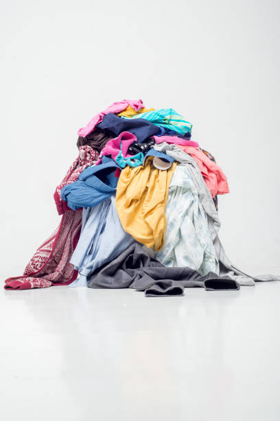 istock pile of used clothes on a light background. Second hand for recycling 1212053708