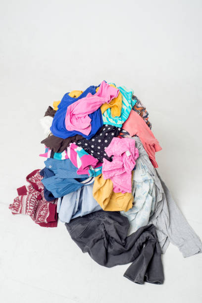 istock pile of used clothes on a light background. Second hand for recycling 1212053717