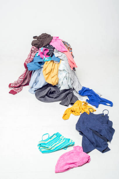 istock pile of used clothes on a light background. Second hand for recycling 1212053719