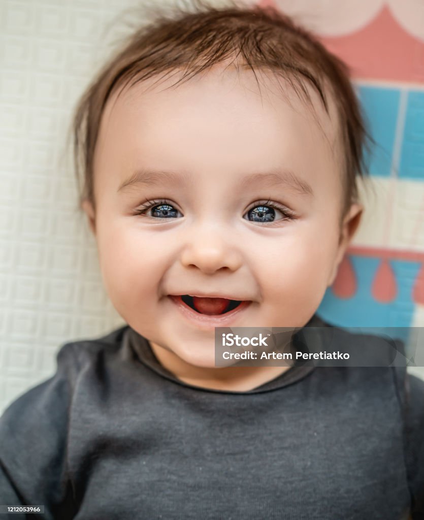The Beautiful Baby Boy Is Smiling Stock Photo - Download Image Now ...