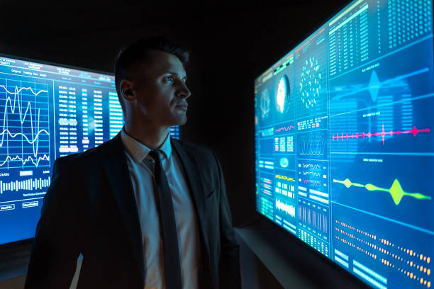 istock The businessman looking on the blue screen 1212054248