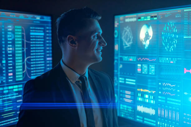 istock The smiling scientist working with large blue monitors in the dark lab 1212054278