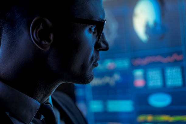 istock The man in suit works with data on a blue screen 1212054279