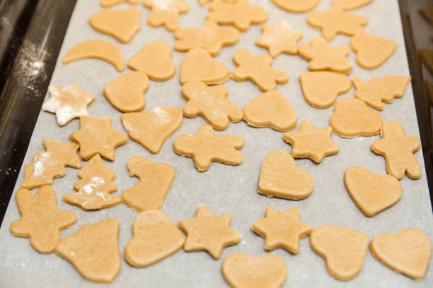 istock cookie cut in different shape for gingerbread cookies on the pan.cooking concept. 1212056140