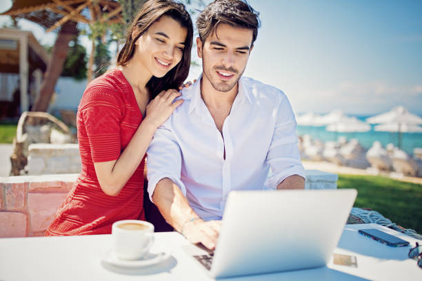 istock Couple is hugging and browsing on the beach 1212057538