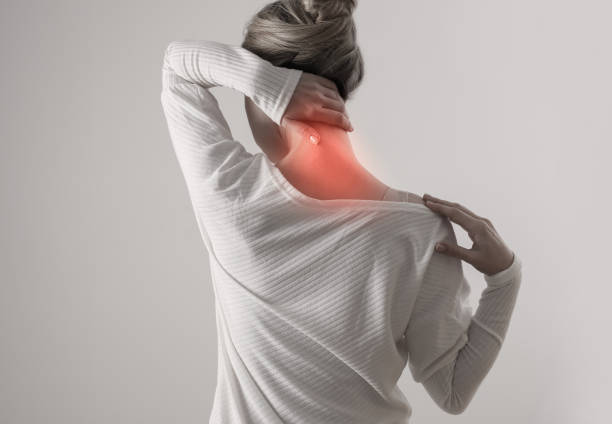 Woman suffering from back and neck pain. Chiropractic, Physiotherapy concept stock photo
