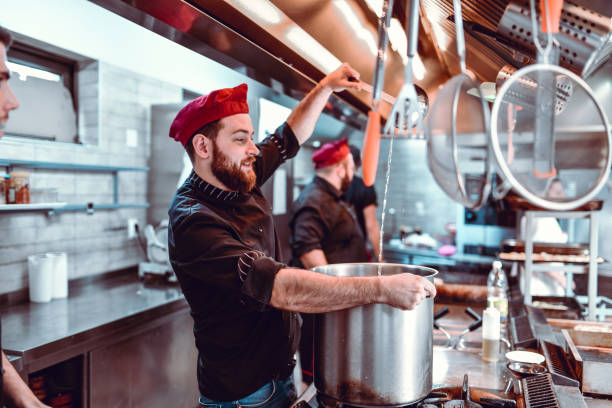 istock Male Cook Checking If The Stew Is Thick Enough 1212059788