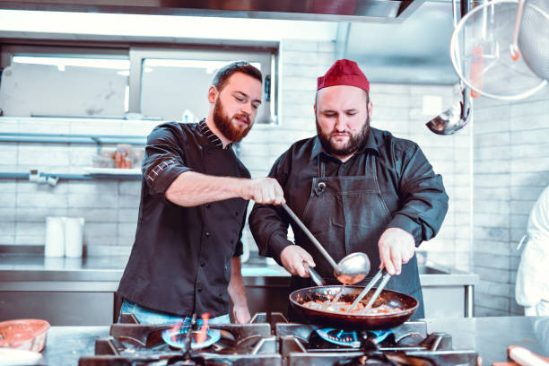 istock Experienced Cooks Working Together Prepare Best Meat Possible 1212059885