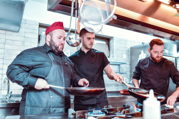 istock Cooks Taking Specific Position In Modern Kitchen To Speed Up The Process 1212059956