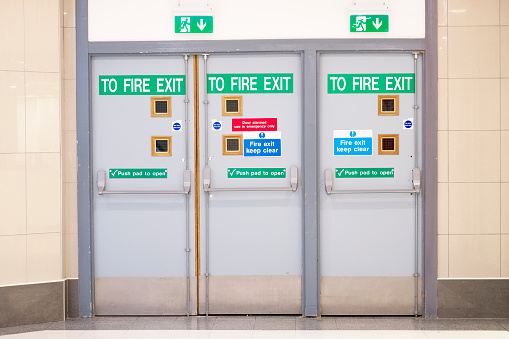 Fire exit glass door at indoor shopping mall for emergency use uk