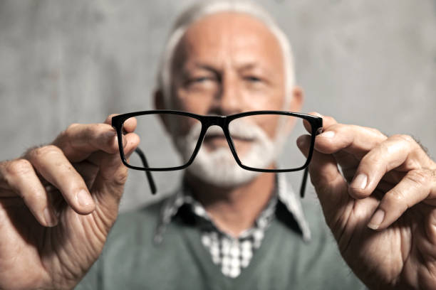 istock Senior man looking through eyeglasses 1212062057