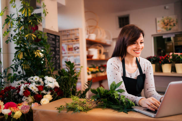 istock Lovely florist using laptop at workplace, portrait. 1212062384