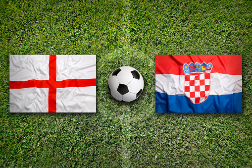 England vs. Croatia flags on a green soccer field