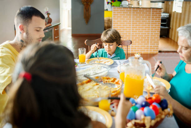 istock Family celebrating an easter lunch in the dining table 1212062473