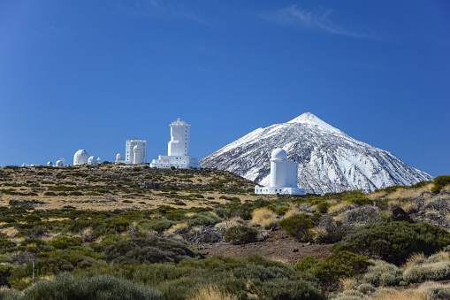 Pico De Teide, Spain - 25th November, 2014: Teide Observatory Astronomical telescopes and Pico De Teide volcano with a snow cap. This volcano is the highest mountain in Spain.