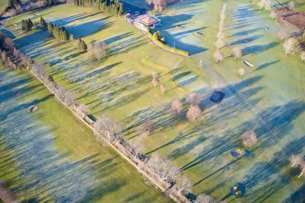 Aerial view of links golf course during summer showing green and bunkers at driving range club house uk