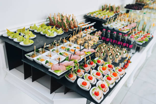 istock Big buffet reception of different delicious food at a wedding celebration. Snacks for guests. Wedding party. Canapes, sushi, fruit, meat, drink, wine, juice. 1212065254