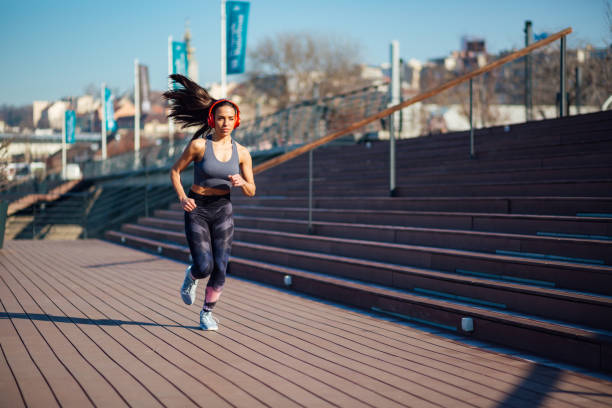 istock Gorgeous young woman jogging 1212067411