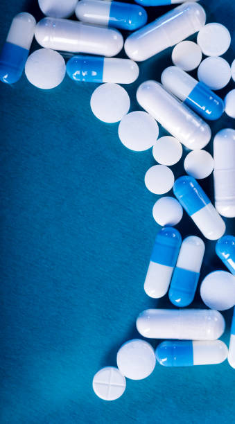 istock Antibiotic and probiotics pills on a blue background. Pharmaceutical concept with empty space for text. 1212068589