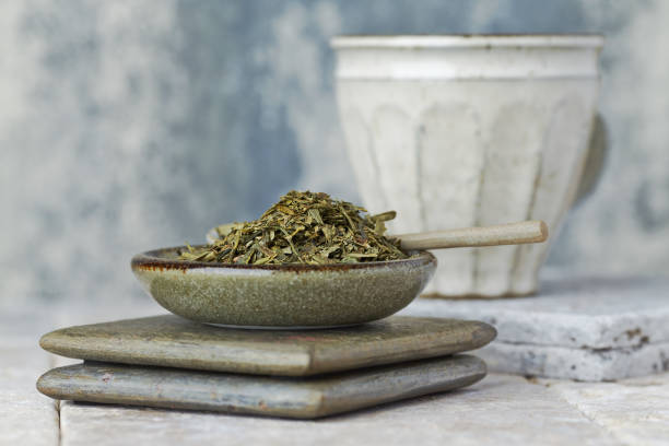 istock Dried Green Tea Leaves on Bright Background. Close up. 1212068688