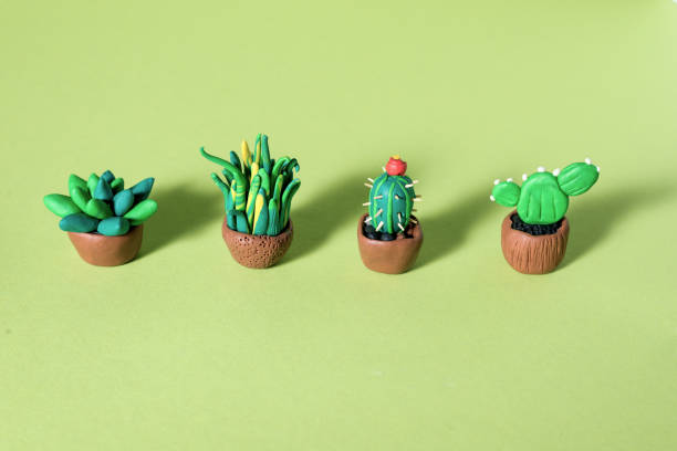 istock Handmade plasticine green cactuses and succulents in a pots. 1212069271