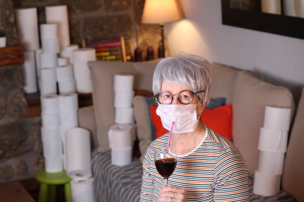 istock Senior woman enjoying a cocktail during quarantine 1212070841