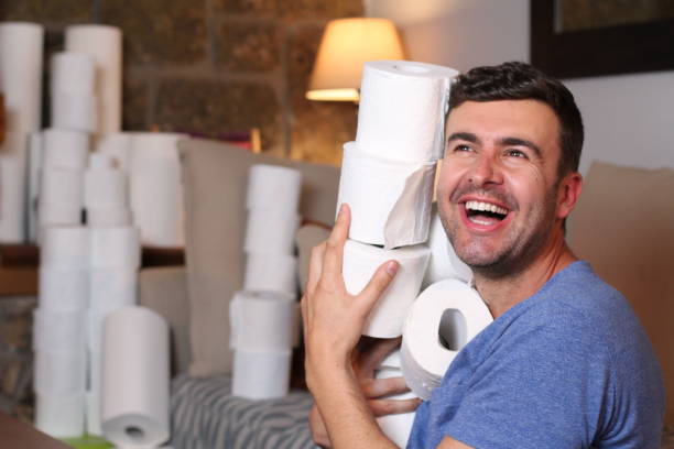 Man stocking up toilet paper at home Man stocking up toilet paper at home. meme photos stock pictures, royalty-free photos & images