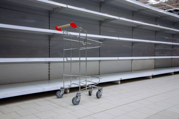 empty shelves and shopping cart in supermarket, all sold out due to panic caused by virus outbreak empty shelves and shopping cart in supermarket, all sold out due to panic caused by virus outbreak sold out photos stock pictures, royalty-free photos & images