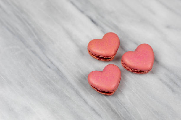 istock Closeup of pink heart shaped macaroons 1212073035