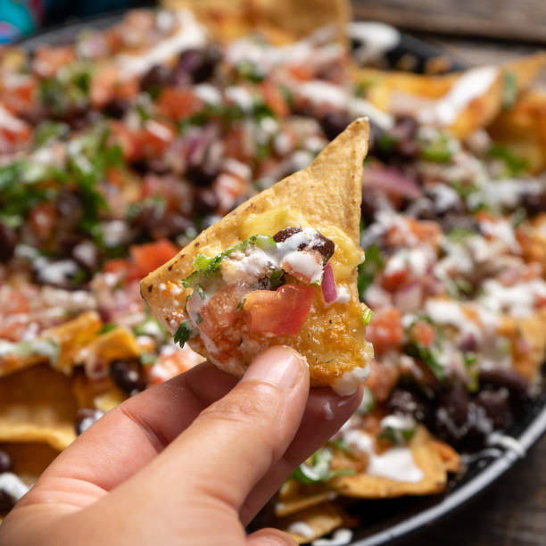 istock Mexican nachos with beans and pico de gallo sauce on rustic background 1212075243