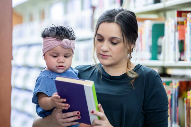 istock Baby and mother in college library 1212075274