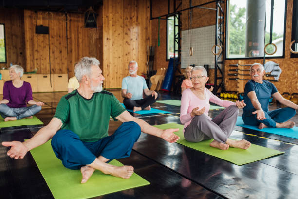 istock Seniors doing yoga together 1212075403
