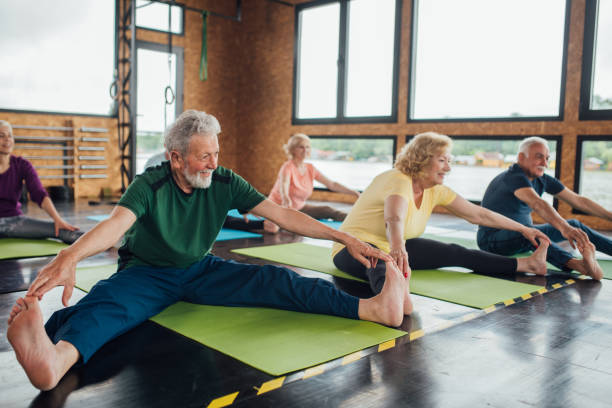 istock Group of seniors stretching on yoga class 1212075410