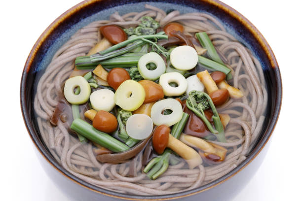 Japanese Sansai soba noodles in a ceramic bowl on white background