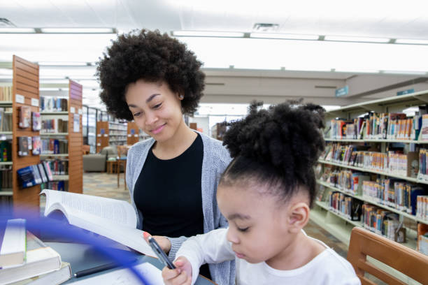 istock Mother brings toddler daughter to study in library 1212076326
