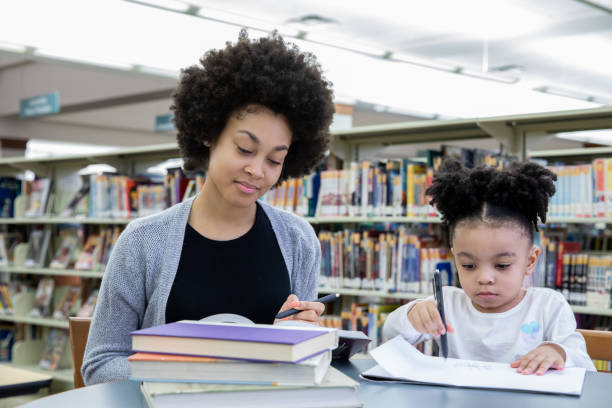 istock Mother and toddler daughter at study group 1212076340