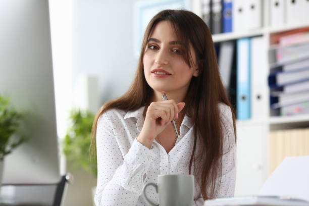 istock Good-looking woman in white blouse 1212076442