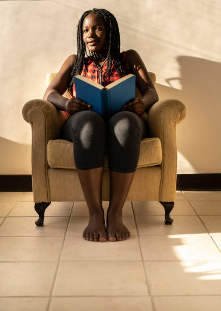istock Woman relaxing at home, reading a book 1212077291