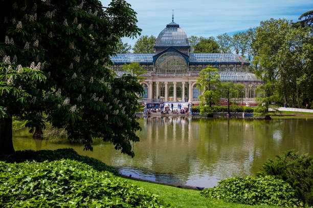 View of the beautiful Palacio de Cristal a conservatory located in El Retiro Park built in 1887 in Madrid Madrid, Spain - May, 2018: View of the beautiful Palacio de Cristal a conservatory located in El Retiro Park built in 1887 in Madrid palacio de cristal photos stock pictures, royalty-free photos & images