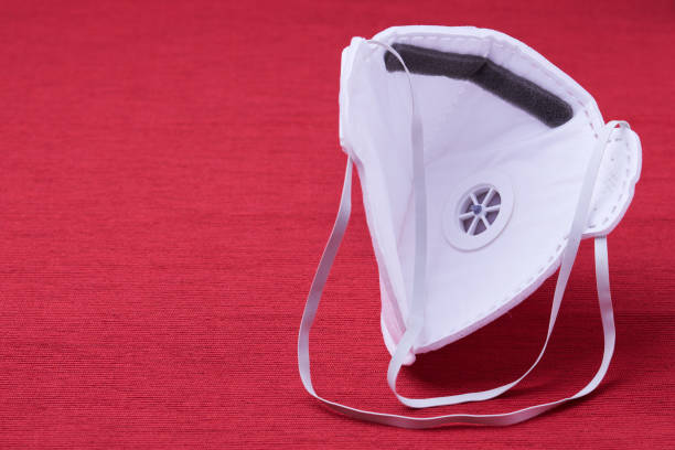 istock White ffp3 face mask with a valve on a red background 1212078480