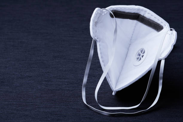 istock White ffp3 face mask with a valve on a dark background 1212079155