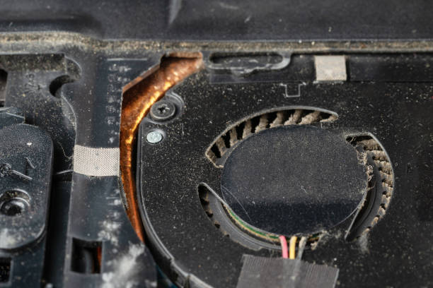 istock Very dirty, dusty laptop cooling system inside. Notebook with cover removed for cleaning and repair 1212079445