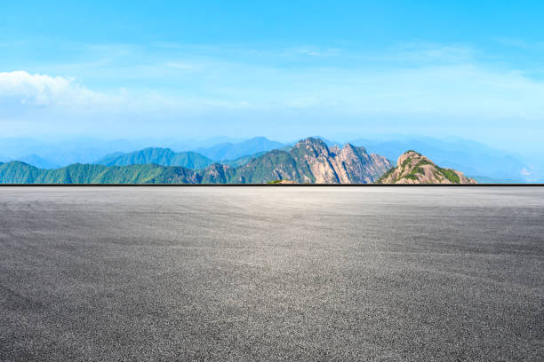 istock Race track road and green mountain with beautiful clouds. 1212083279