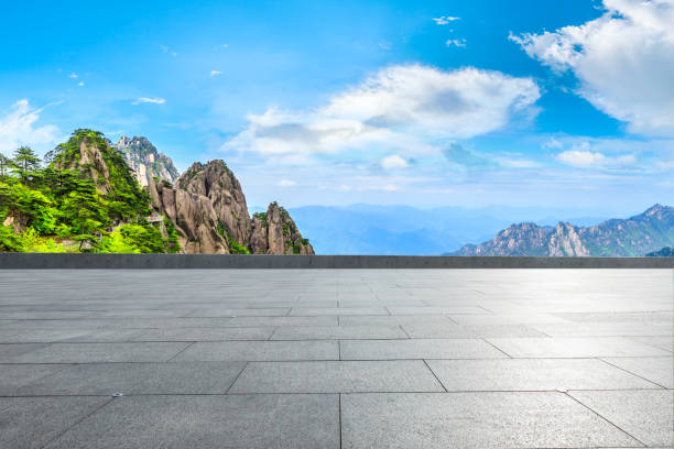 istock Empty floor and green mountain with beautiful clouds. 1212085792