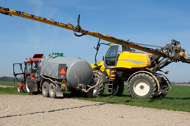 istock Pouring and pumping chemical for machinery sprayer 121208935