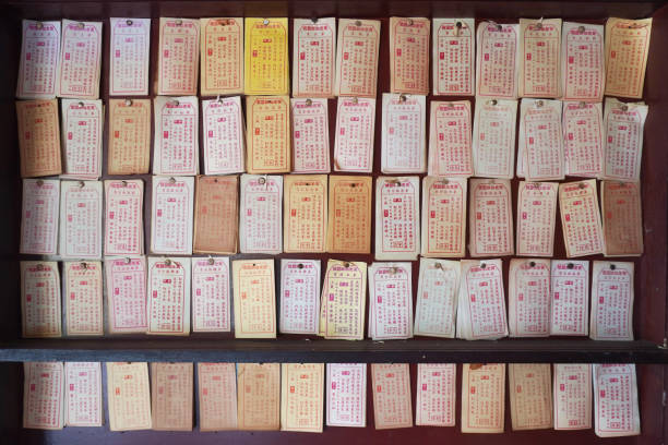 Pray and draw divination sticks at a temple, with the unsigned answer paper on the wall.