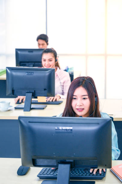 istock Young customer service women agent with headsets and computer working at office. 1212097758