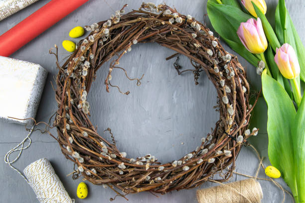 istock Easter wreath, yellow Easter eggs around tulips, gifts and wrapping paper 1212099354