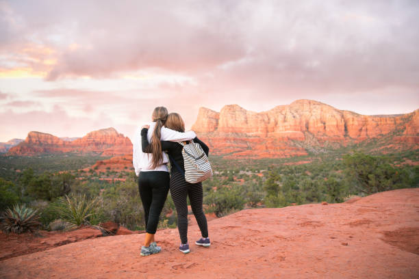 Hiking in Sedona at sunset. Lifelong friends love hiking outdoors. When they are together, the laughter, fresh air and strong connection with each other is all they need. sedona photos stock pictures, royalty-free photos & images